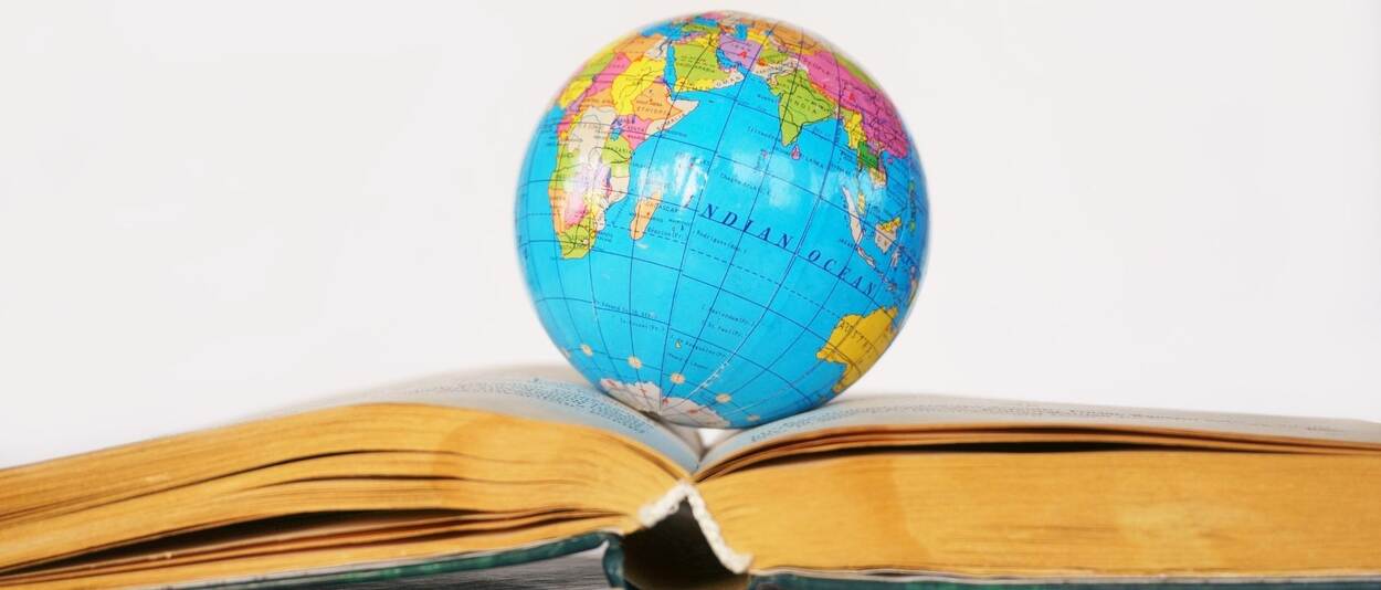 Picture of a globe which rests on an open book