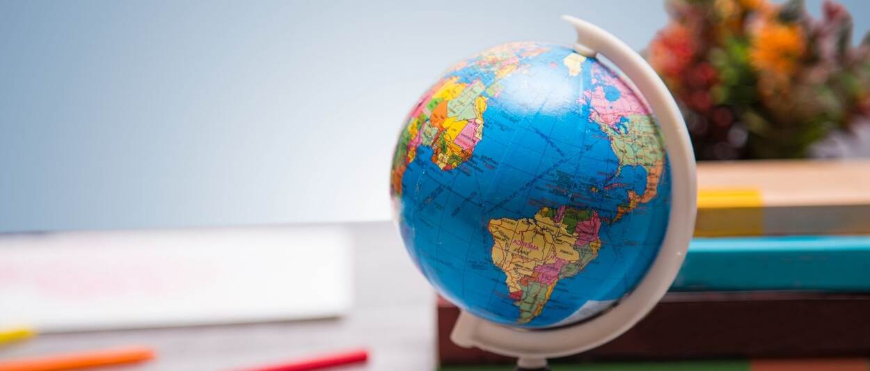 a globe with some books in the background